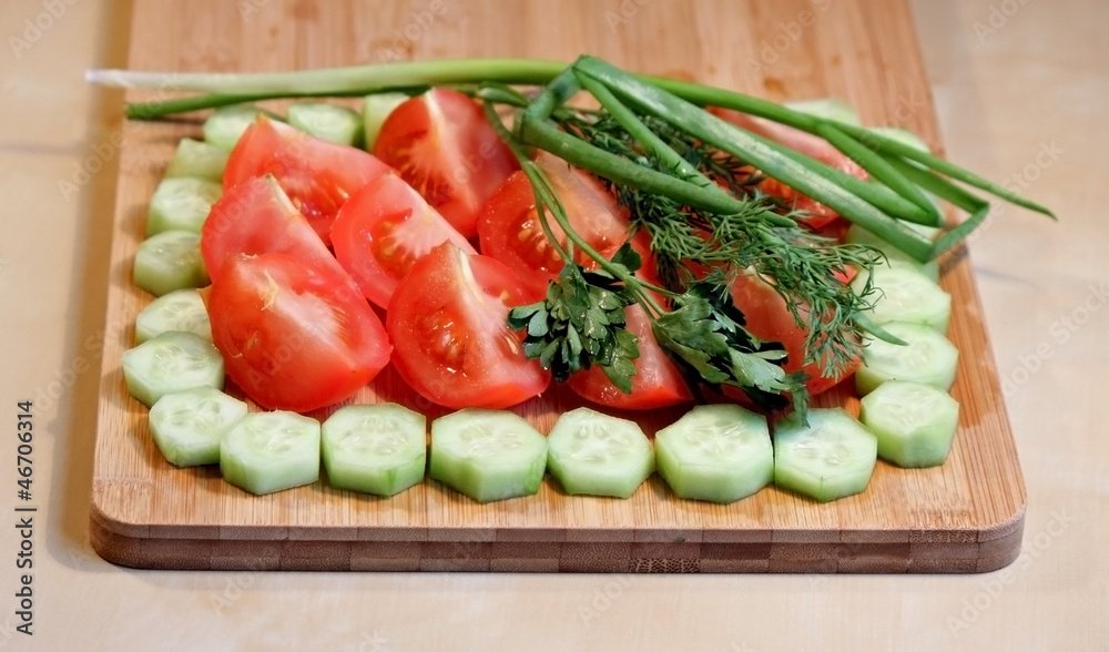 Fresh cut vegetables and greens on the chopping board Fresh cut vegetables and greens on the chopping board