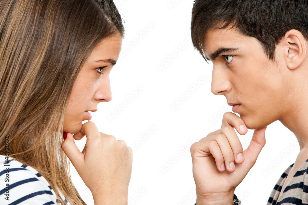 Teen coupe looking at each other wondering. Teen coupe looking at each other wondering.