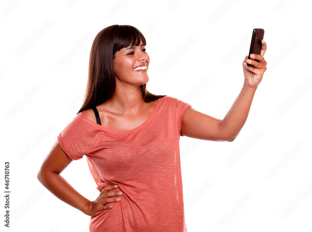 Smiling woman taking a photo with her cellphone Smiling woman taking a photo with her cellphone