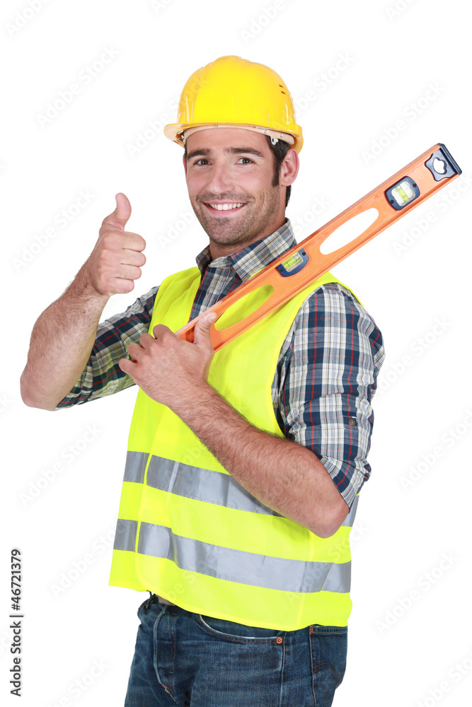 Man with spirit-level giving the thumbs-up Man with spirit-level giving the thumbs-up