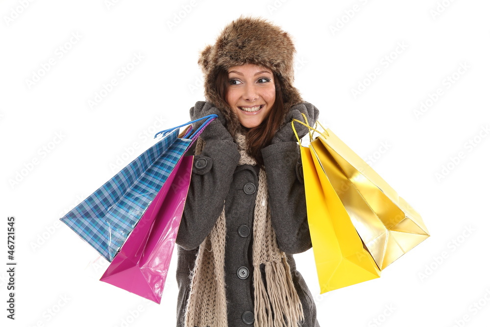 Woman in winter clothes with gifts and shopping bags smiling