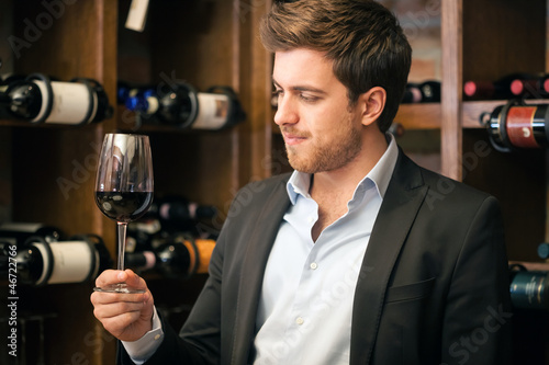 Man tasting a glass of red wine