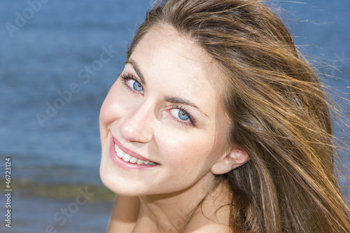 Photo of a young woman by the sea