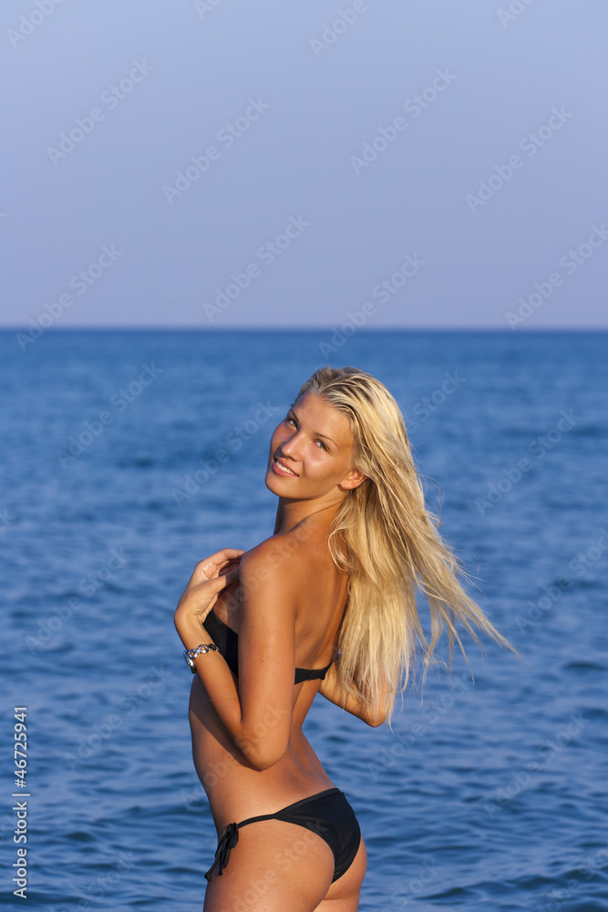 Blonde in the water waving hair