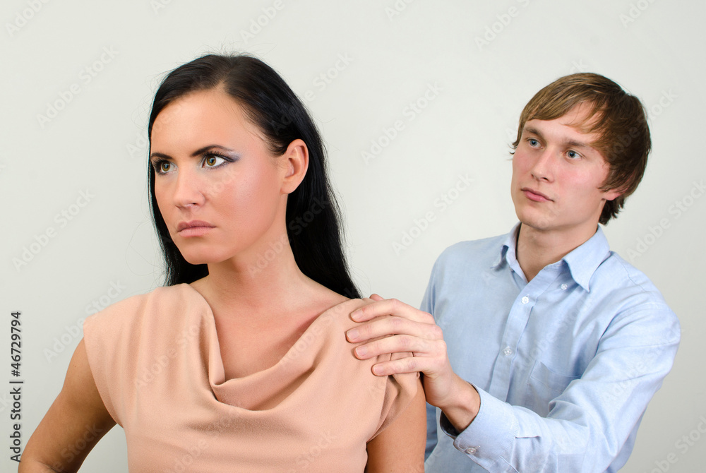 Young couple quarreling. Man asks for forgiveness.