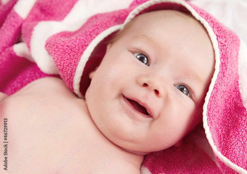 Adorable baby girl in pink blanket smiling Adorable baby girl in pink blanket smiling