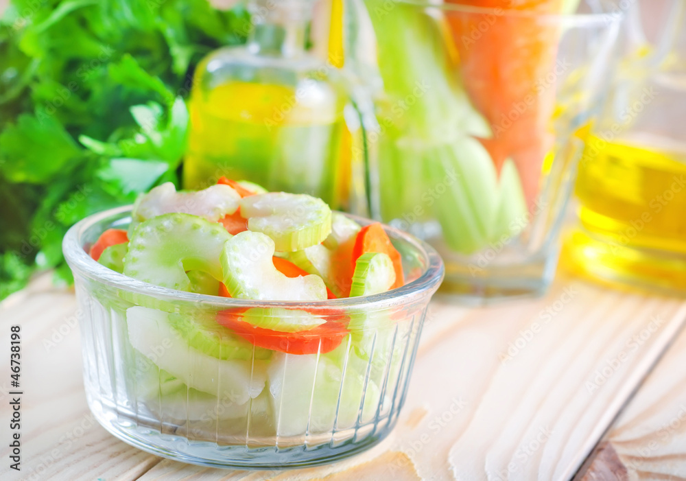 fresh salad with carrot and celery, salad in glass bowl fresh salad with carrot and celery, salad in glass bowl