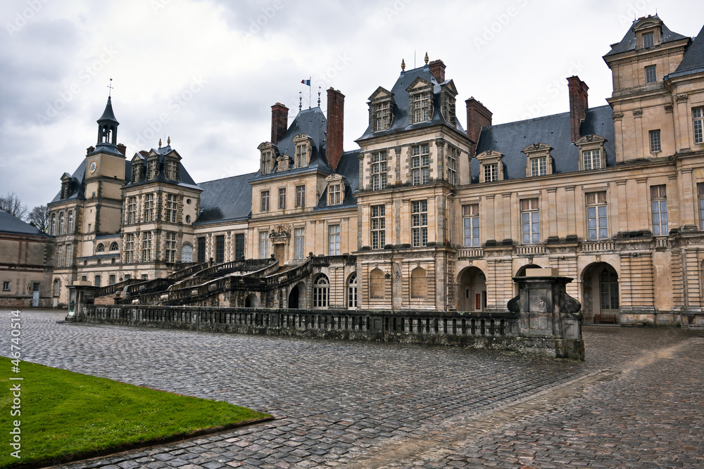 Entrance to the Chateau de Fontainebleau on a rainy day, France