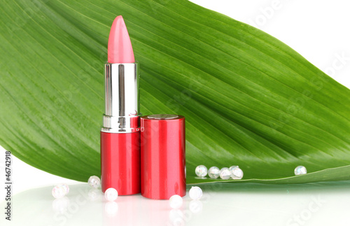 lipstick on green leaf isolated on white