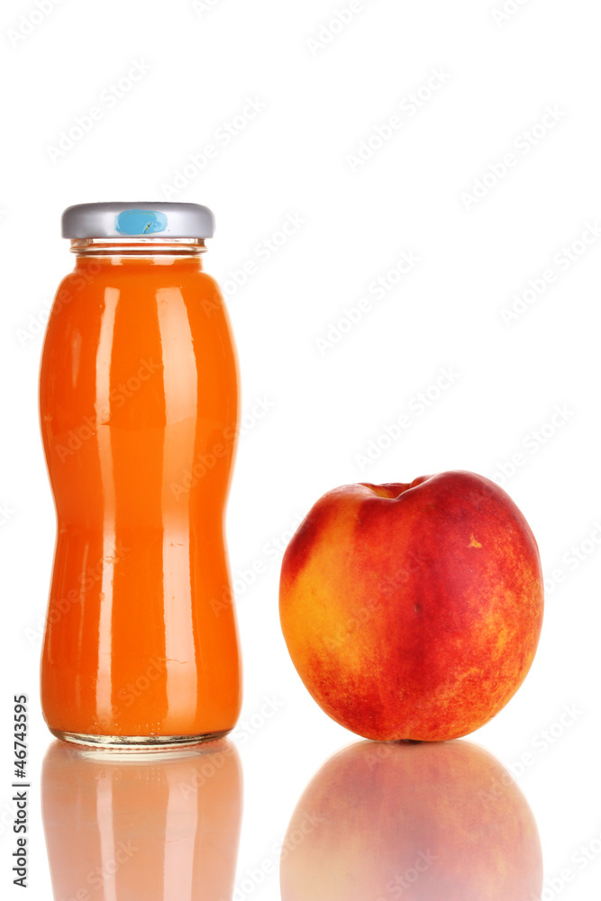 Delicious peach juice in glass bottle and peach next to it Delicious peach juice in glass bottle and peach next to it