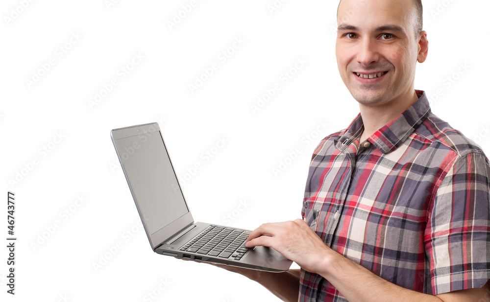 Portrait of handsome young man smiling using laptop Portrait of handsome young man smiling using laptop