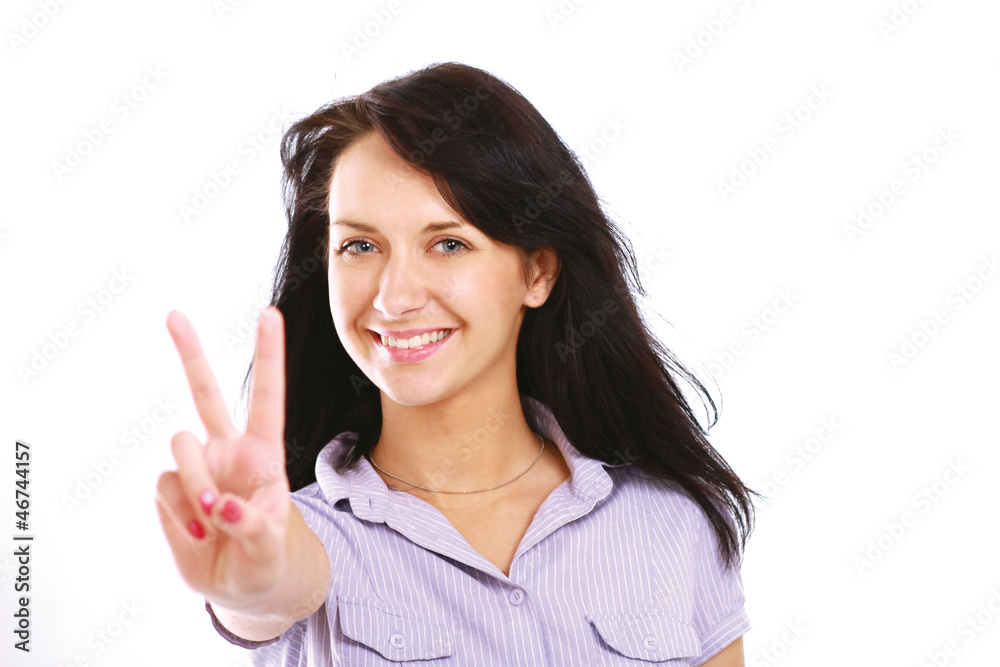 Excited young woman showing victory sign isolated Excited young woman showing victory sign isolated