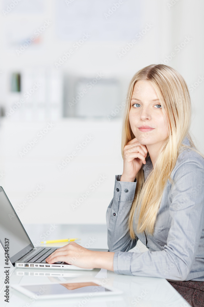 junge angestellte mit laptop im büro junge angestellte mit laptop im büro