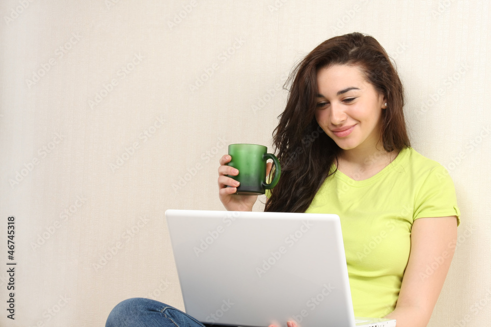 Happy casual girl with laptop at home isolated