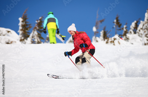 Young female skier on a snowy slope