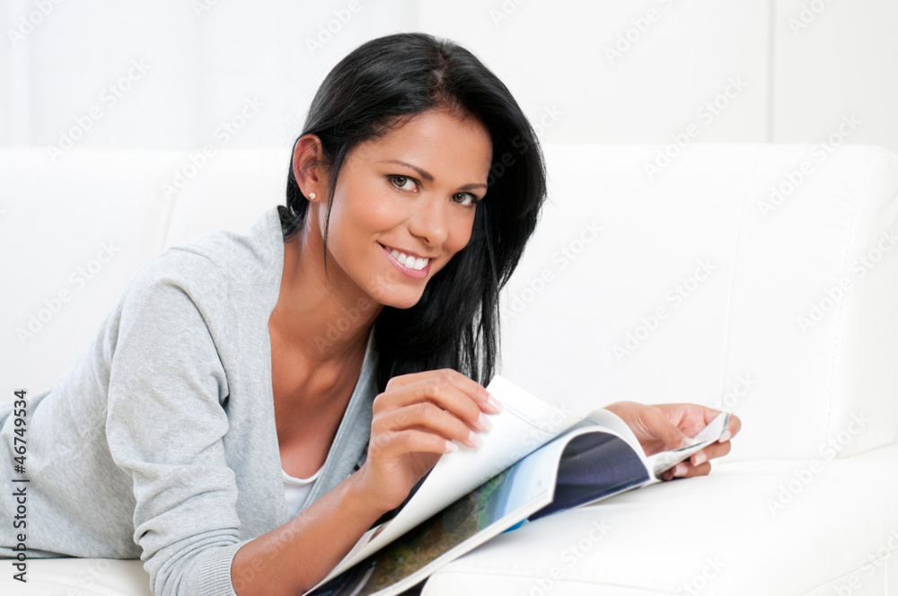 Young woman reading magazine Young woman reading magazine