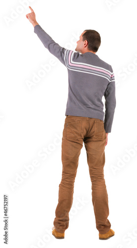 Back view of pointing young men in sweater and jeans