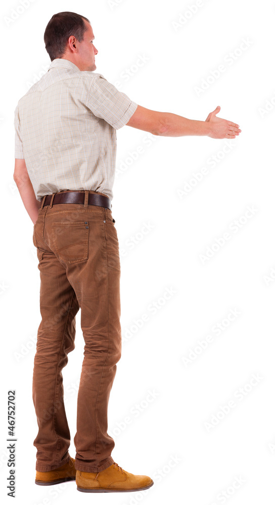 back view of businessman in movement reaches out to shake hands back view of businessman in movement reaches out to shake hands