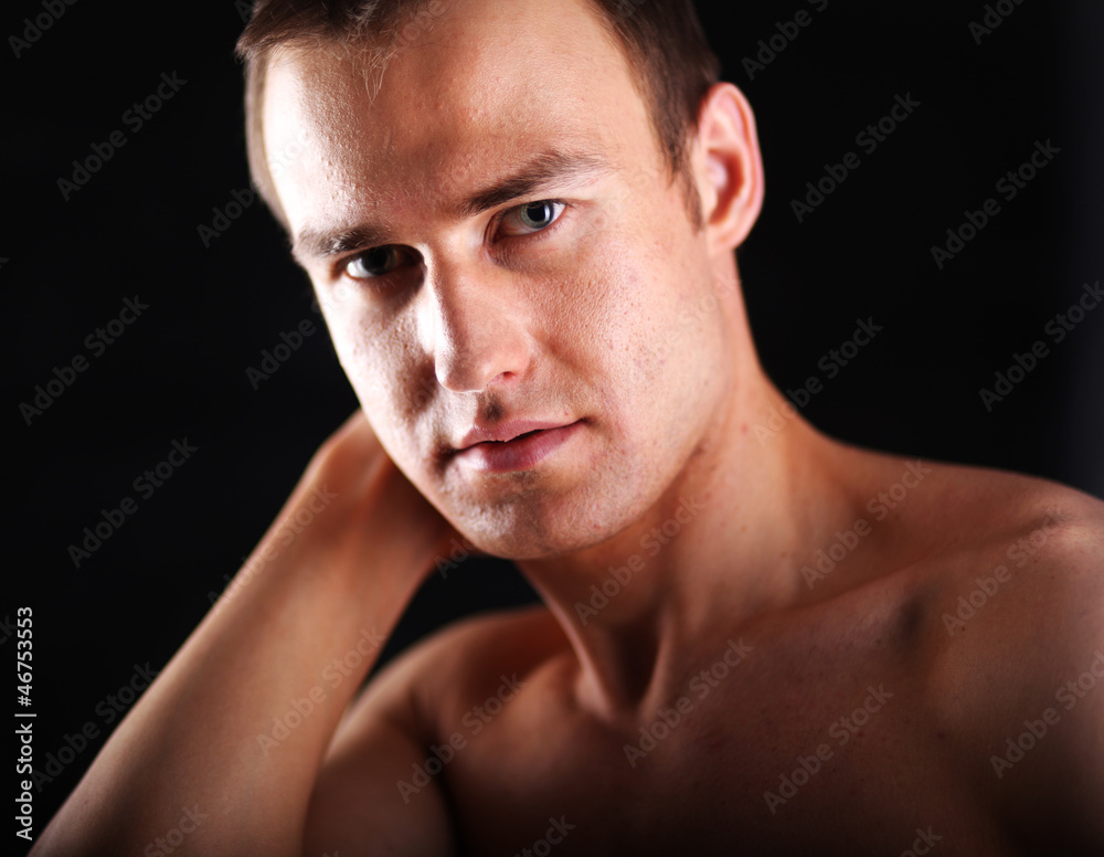 Portrait of a naked muscular man, isolated on black background Portrait of a naked muscular man, isolated on black background