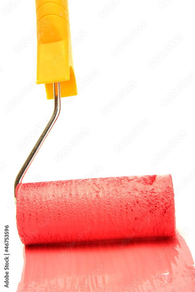 Obraz premium Paint roller with red paint isolated on white