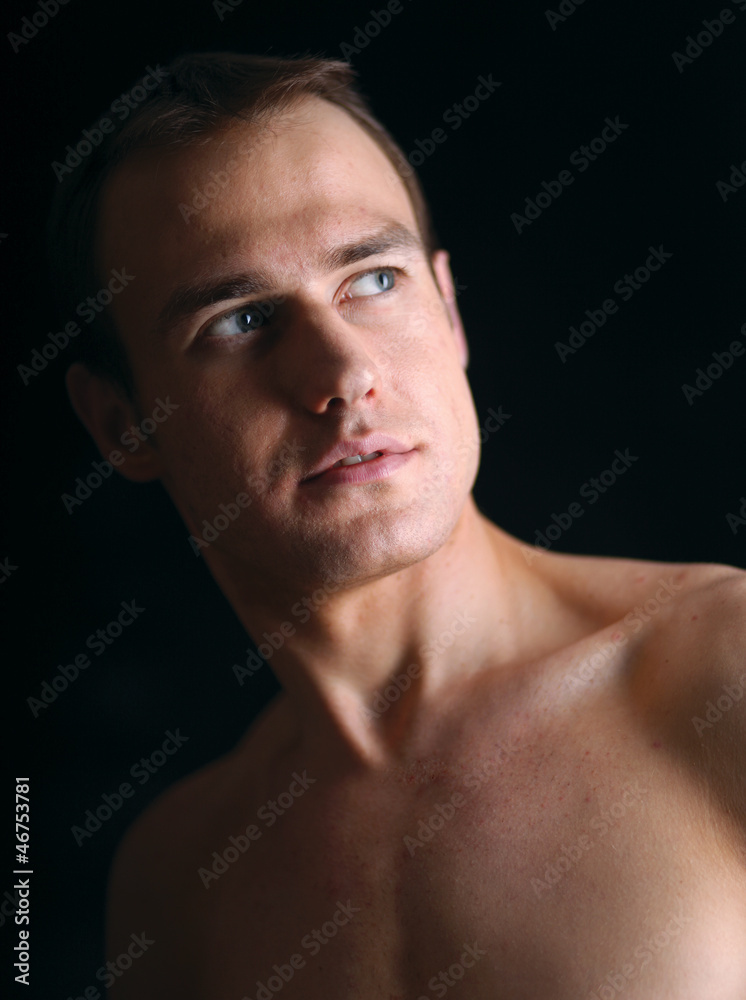 Portrait of a naked muscular man, isolated on black background Portrait of a naked muscular man, isolated on black background