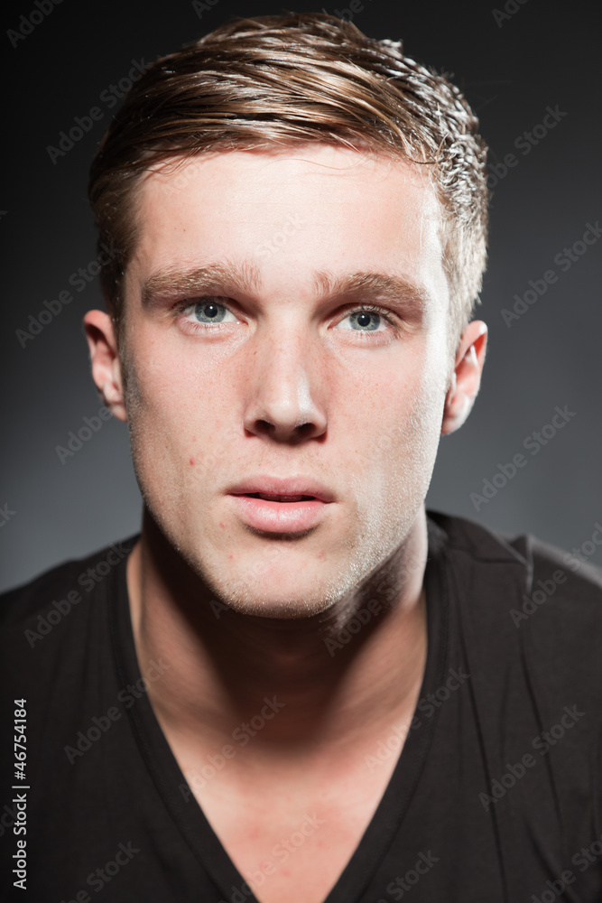 Fototapeta premium Fashion beauty portrait of young man with short brown hair.