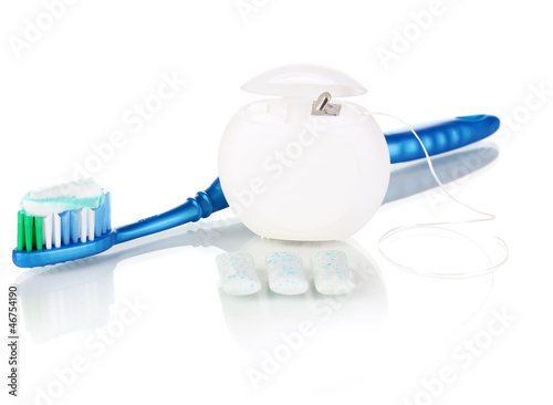 Toothbrush, chewing gum and dental floss isolated on white