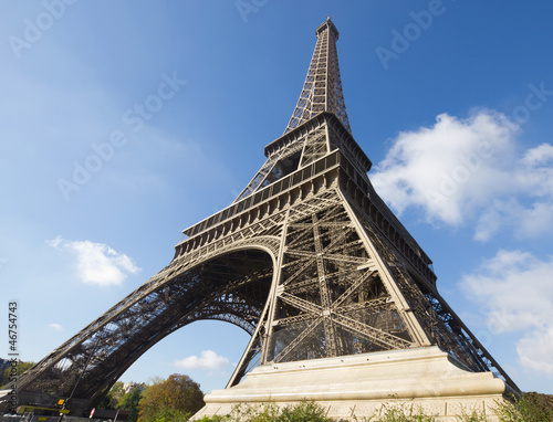 sunlit Eiffel Tower, Paris, against blue sky