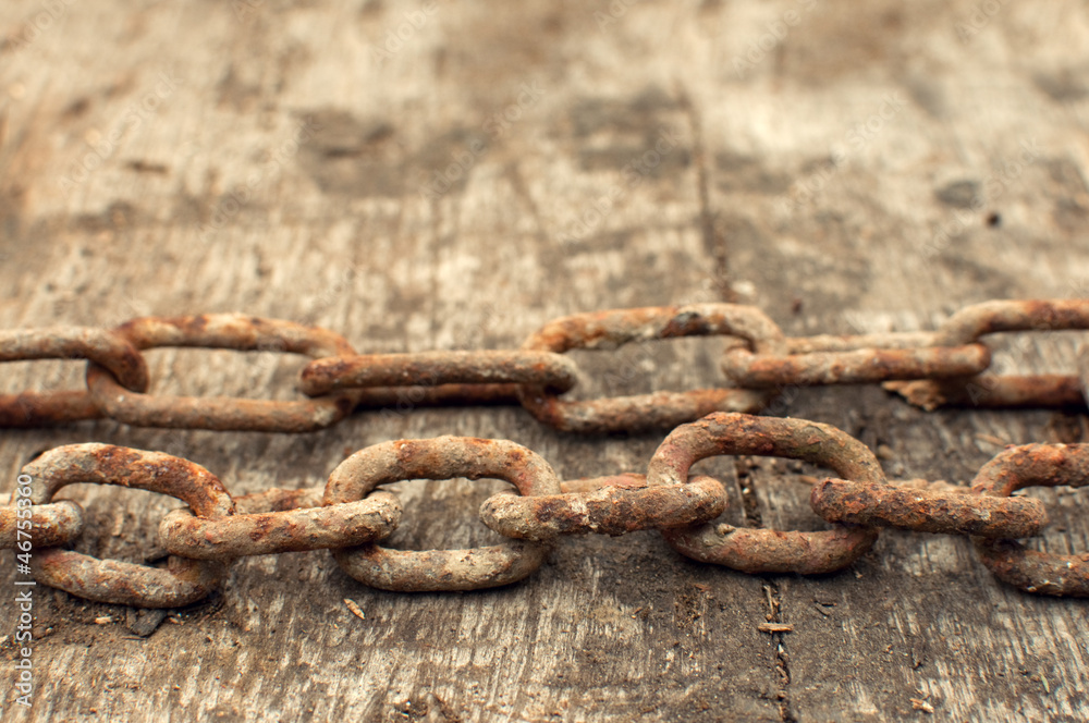 Rusty chain and weathered wood background Rusty chain and weathered wood background