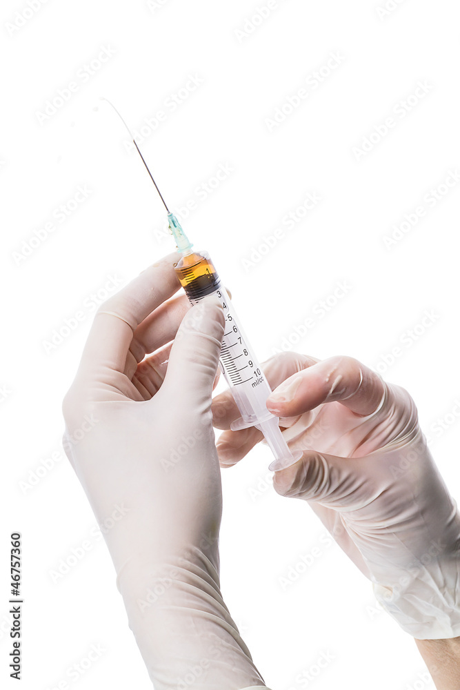 Syringe in doc's hand Syringe in doc's hand