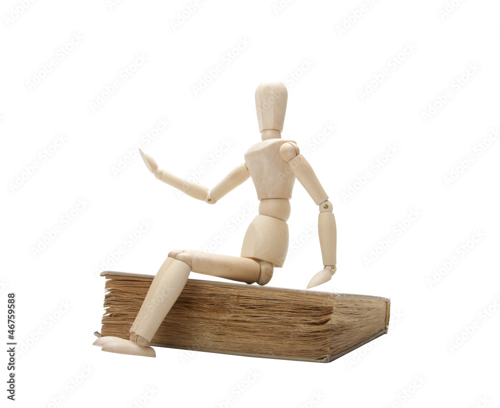 Wooden man and book, isolated on white Wooden man and book, isolated on white