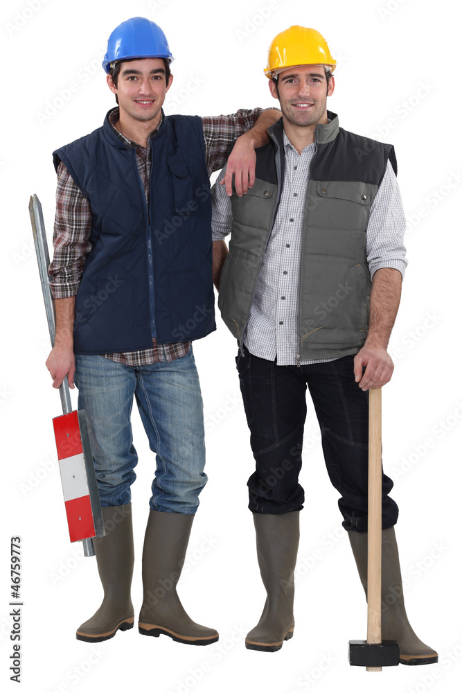 Two manual worker friends stood together Two manual worker friends stood together