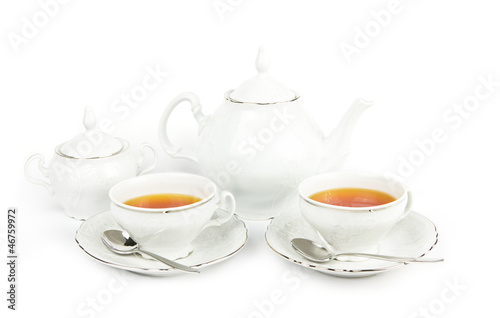 Tea cups, tea pot and sugar on white