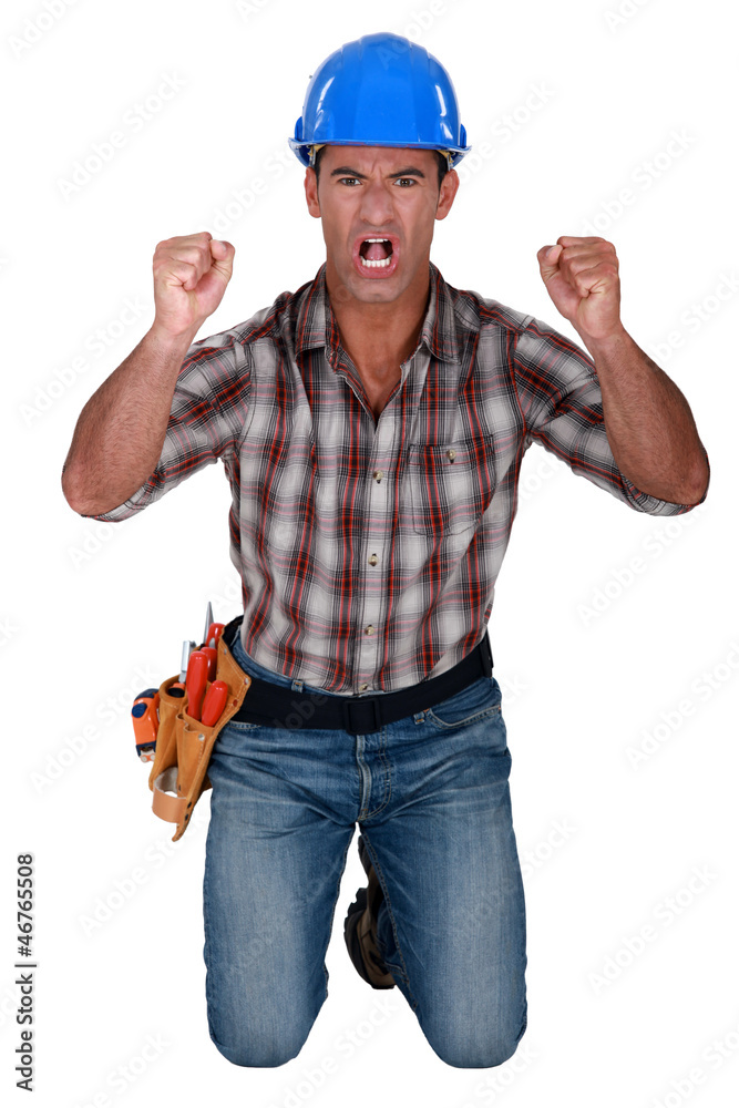 craftsman kneeling and raising his hands