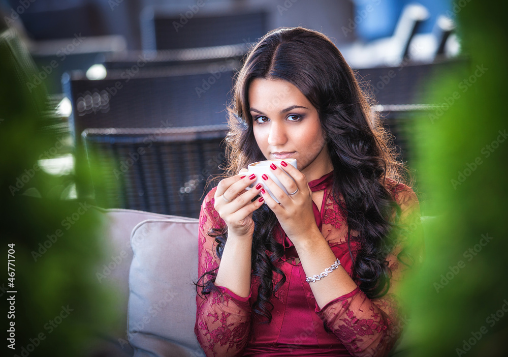 Elegant woman with a tea mug in cafe Elegant woman with a tea mug in cafe