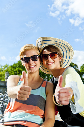 Two  beautiful woman with sunglasses on natural background
