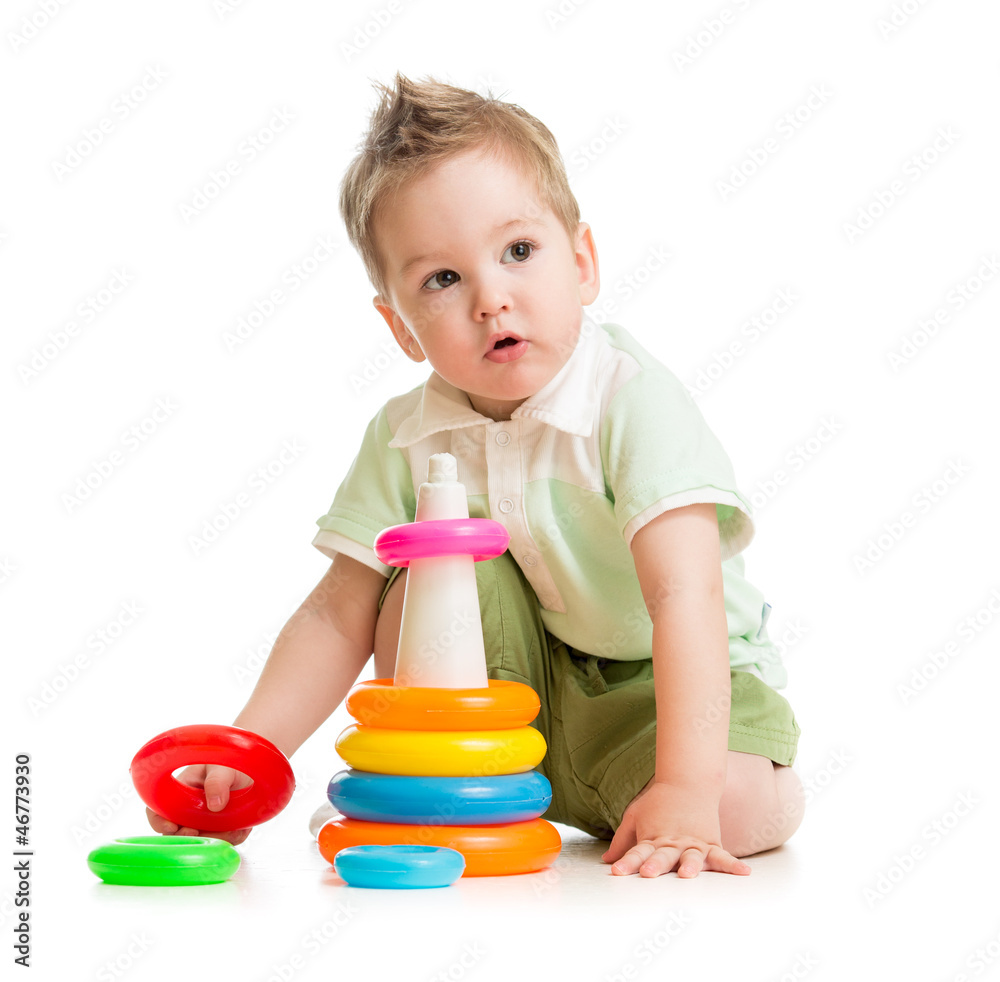Cute kid playing colorful tower isolated on white Cute kid playing colorful tower isolated on white