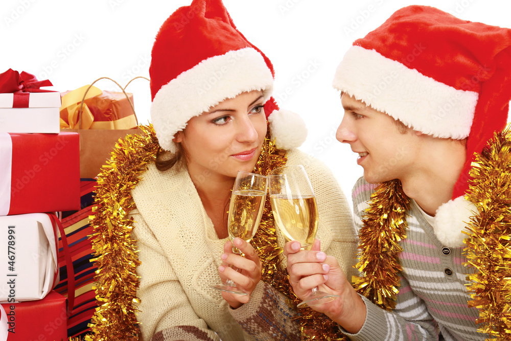 Young people in santa hat drinking champagne Young people in santa hat drinking champagne