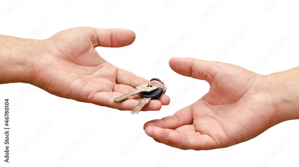 Male hand holding  apartment keys and handing it over to another