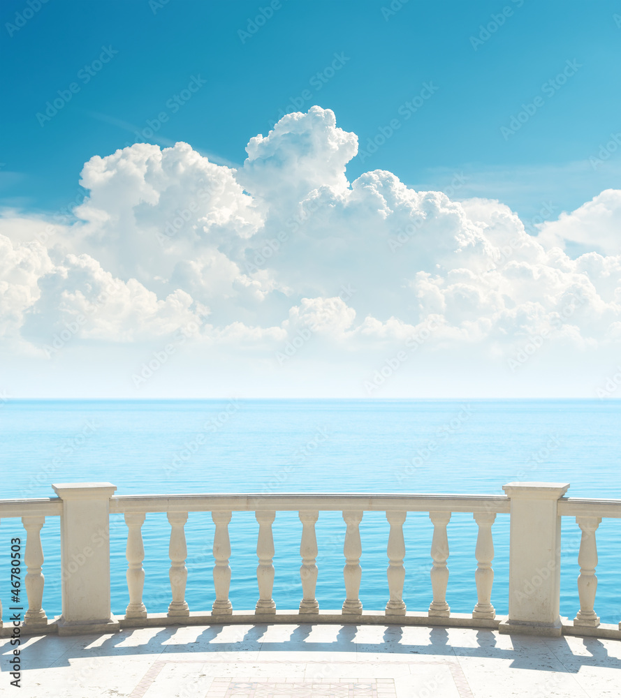 balcony near sea and clouds over it
