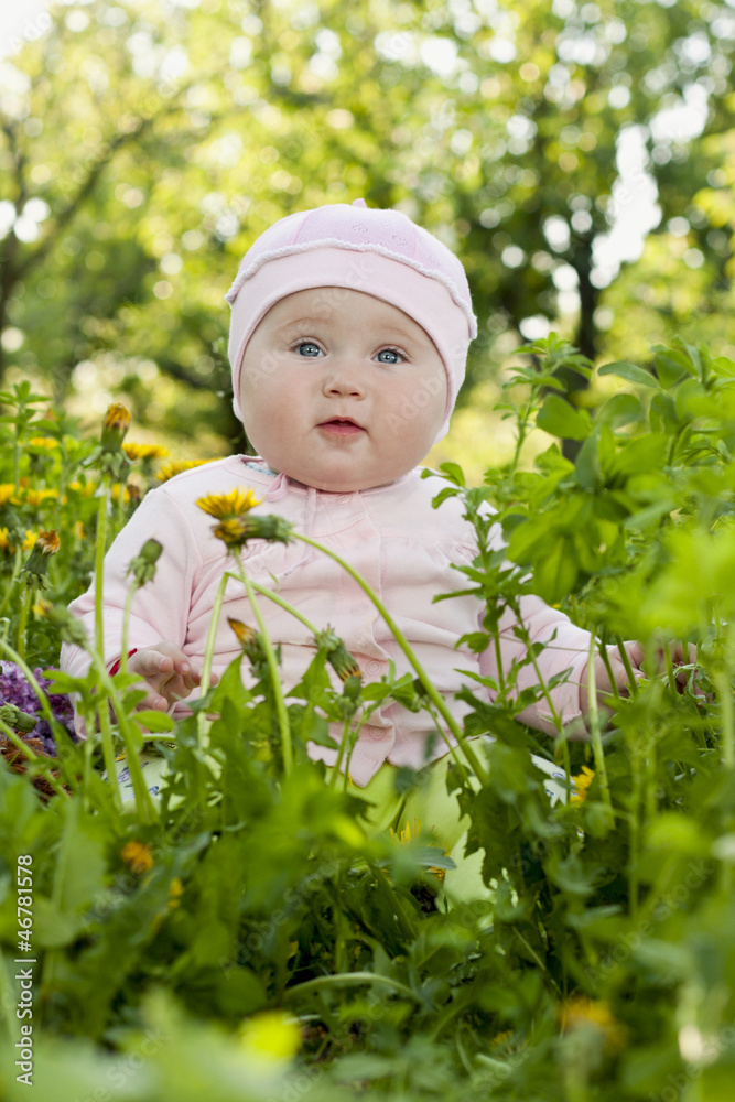 little girl on a background of green grass little girl on a background of green grass
