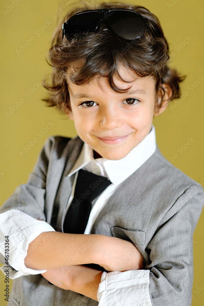 portrait of little stylish boy outdoors