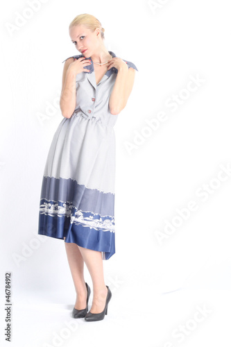 Elegant woman with blue dress, posing at the studio