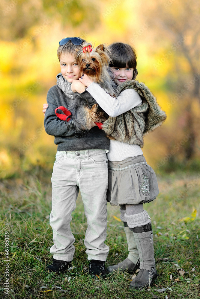 portrait of little boy and girl outdoors in autumn