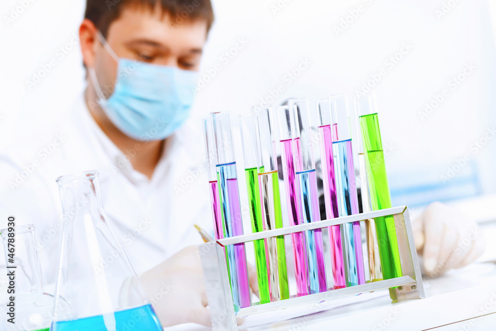 Young male scientist working in laboratory Young male scientist working in laboratory