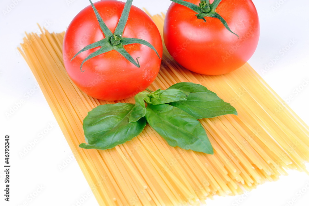 raw spaghetti, tomatoes and basil on white, soft shadows raw spaghetti, tomatoes and basil on white, soft shadows