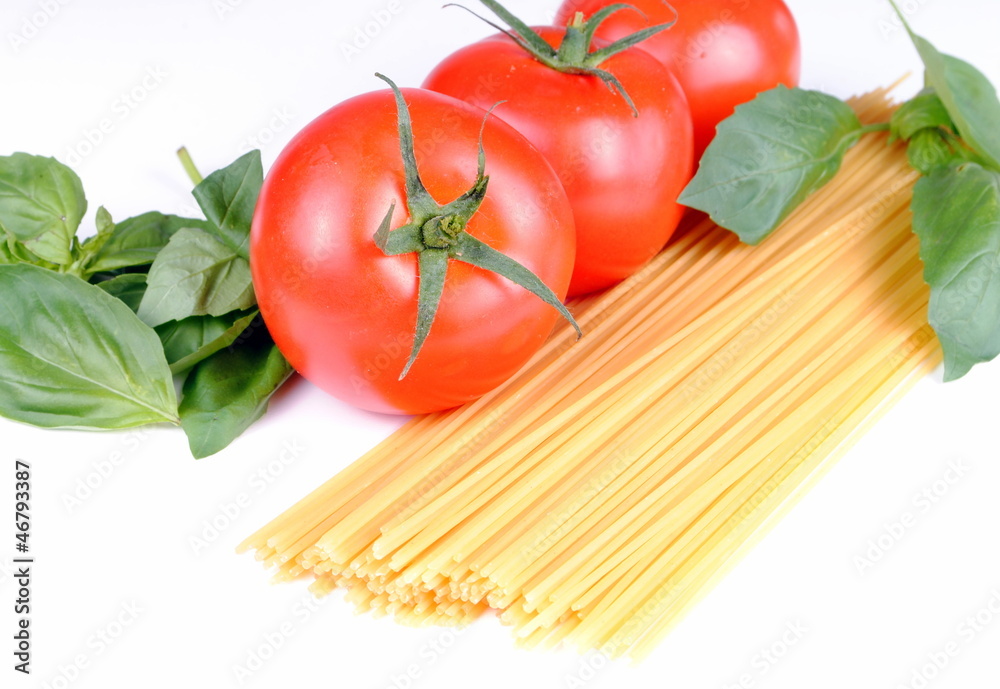 raw spaghetti, tomatoes and basil on white, soft shadows raw spaghetti, tomatoes and basil on white, soft shadows