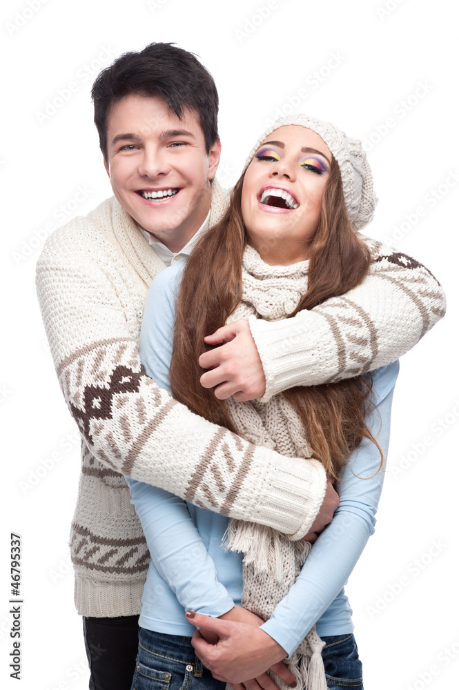 young smiling couple in winter clothing embracing
