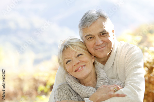 Senior couple embracing each other in countryside
