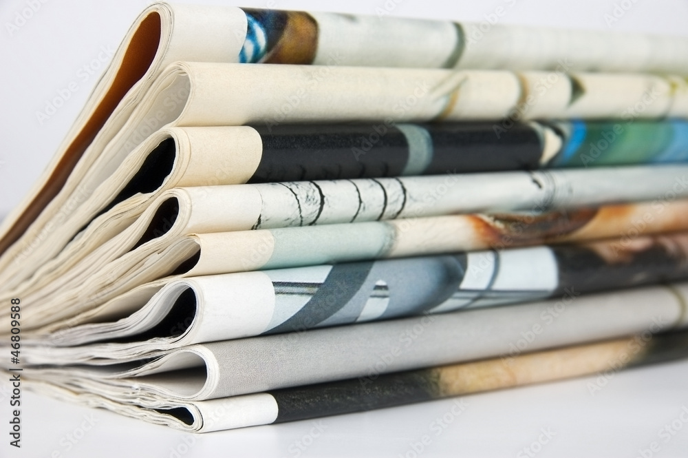 Pile of newspapers over white background Pile of newspapers over white background